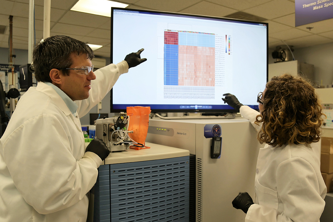 Trevor Glaros, Ph.D., and Elizabeth Dhummakupt, Ph.D., analyze data from a test of biomarkers found in blood to determine opioid exposure.
