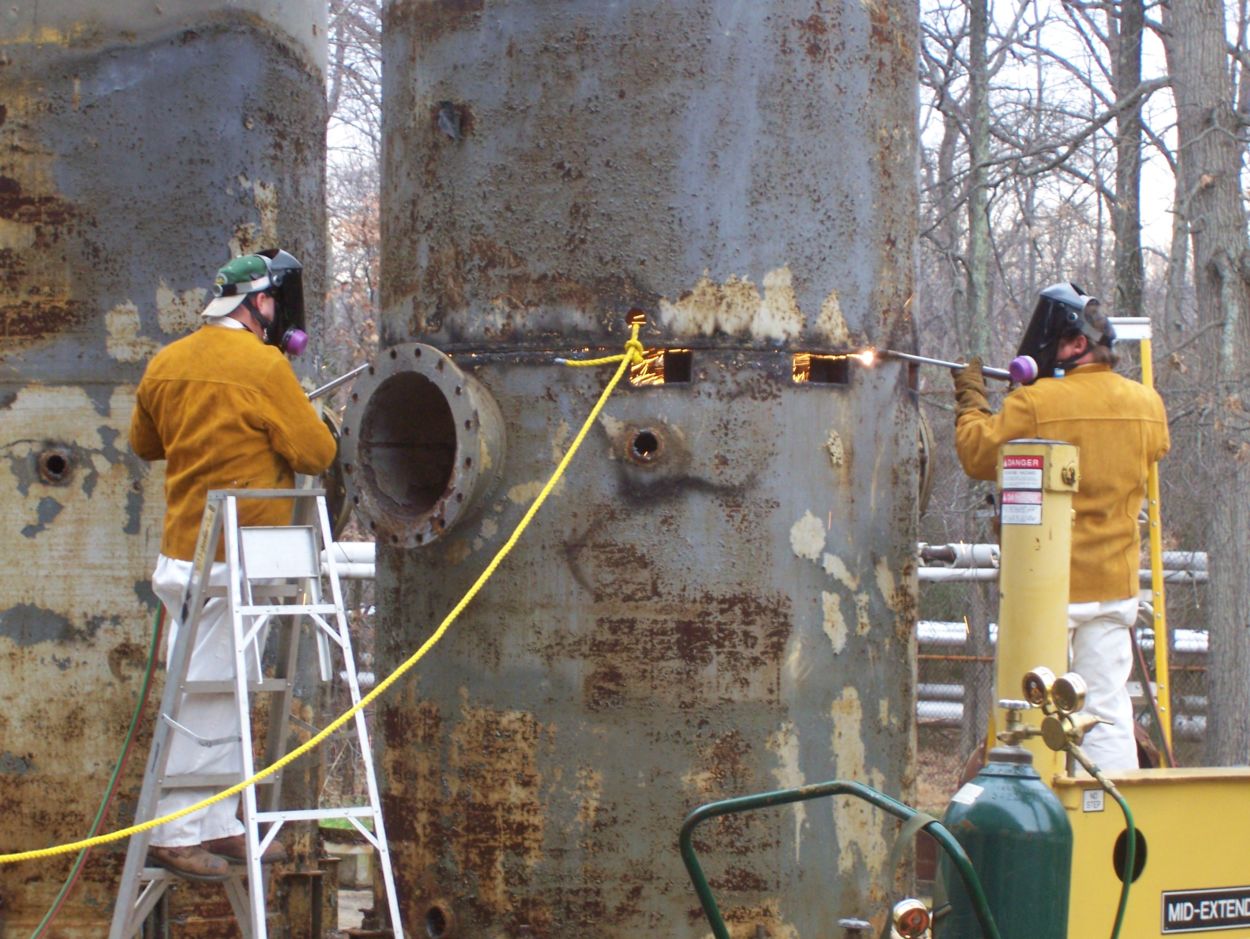 CBARR technicians conduct operations on a neutralization tower as part of the demolition of a pilot plant facility at the Edgewood Area of Aberdeen Proving Ground.