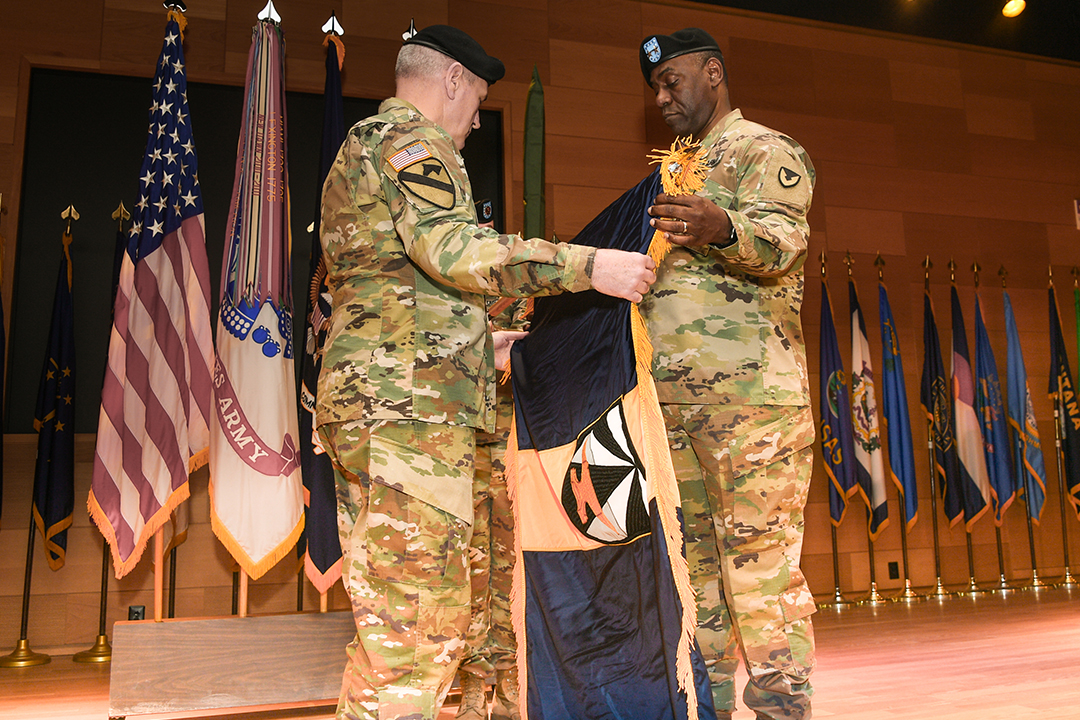 Gen. John M. Murray, commanding general Army Futures Command, and Maj. Gen. Cedric T. Wins, commanding general Combat Capabilities Development Command, uncase the official flag, signifying the transition of the U.S. Army Research, Development and Engineering Command from Army Materiel Command to AFC. (Photo Credit: Conrad Johnson)