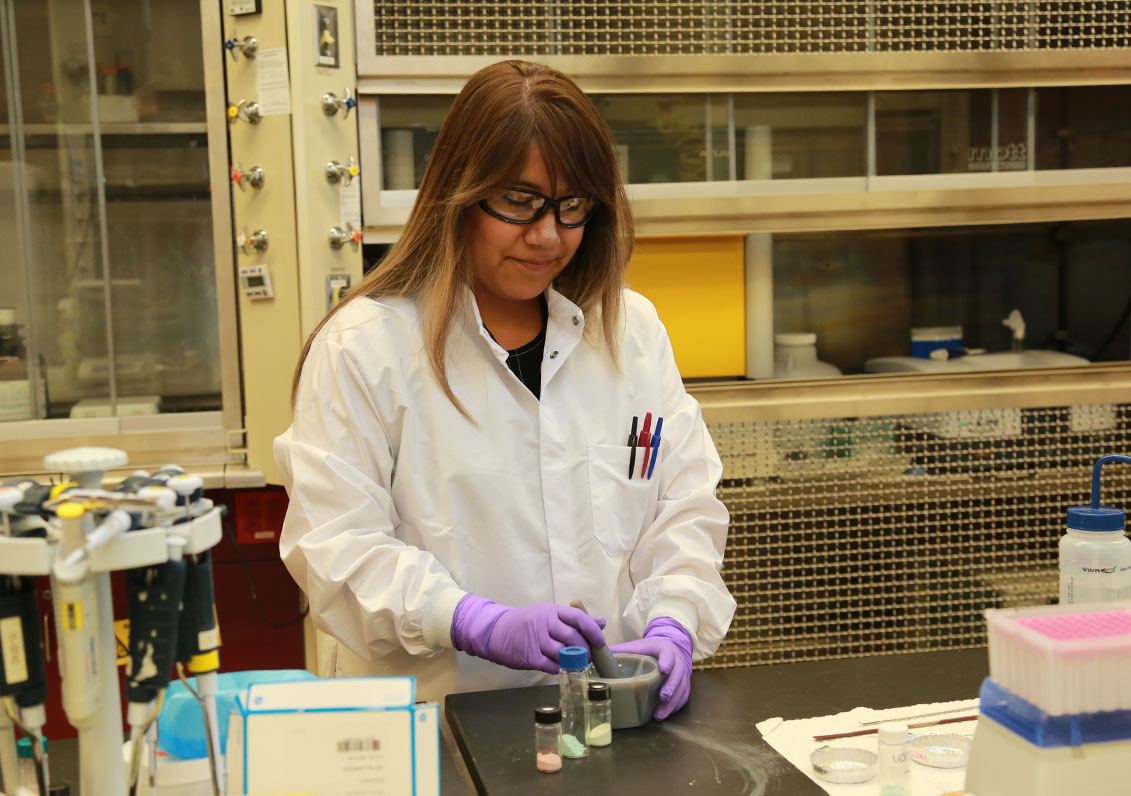 Jennifer Soliz, Ph.D., pulverizes self-indicating colormetric response materials with a mortar and pestle. (Photo Credit: CCDC Chemical Biological Center photo by Shawn Nesaw)