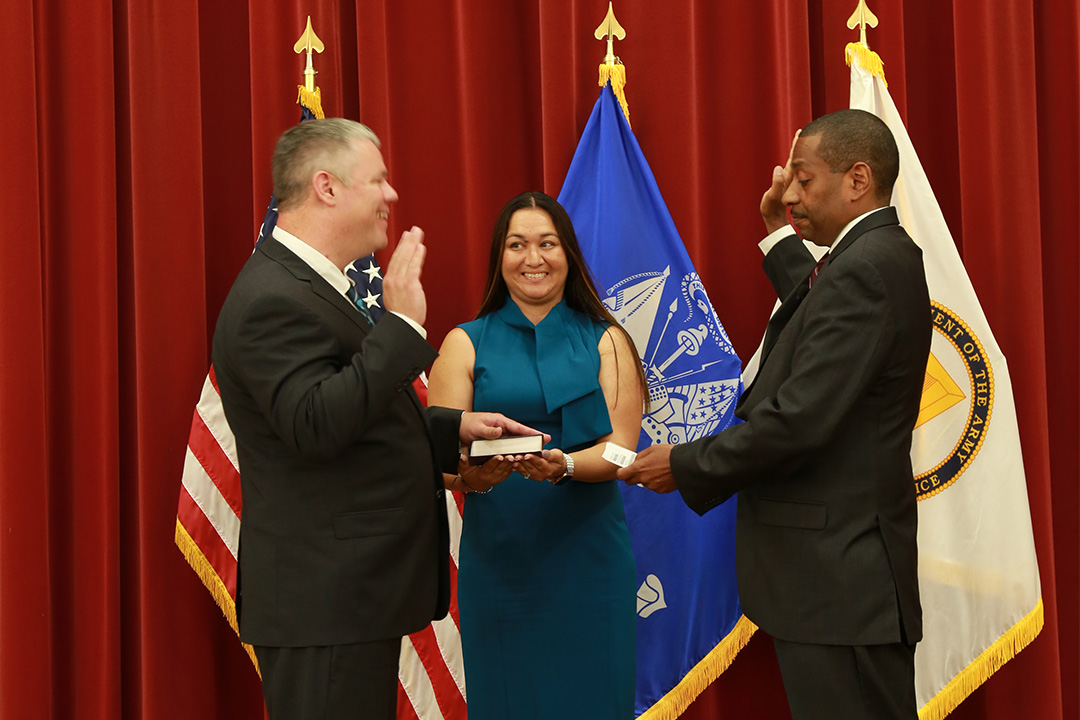Cox, with wife Joy Ginter Cox and Director Moore, takes the Oath of Office. Photo by Shawn Nesaw.
