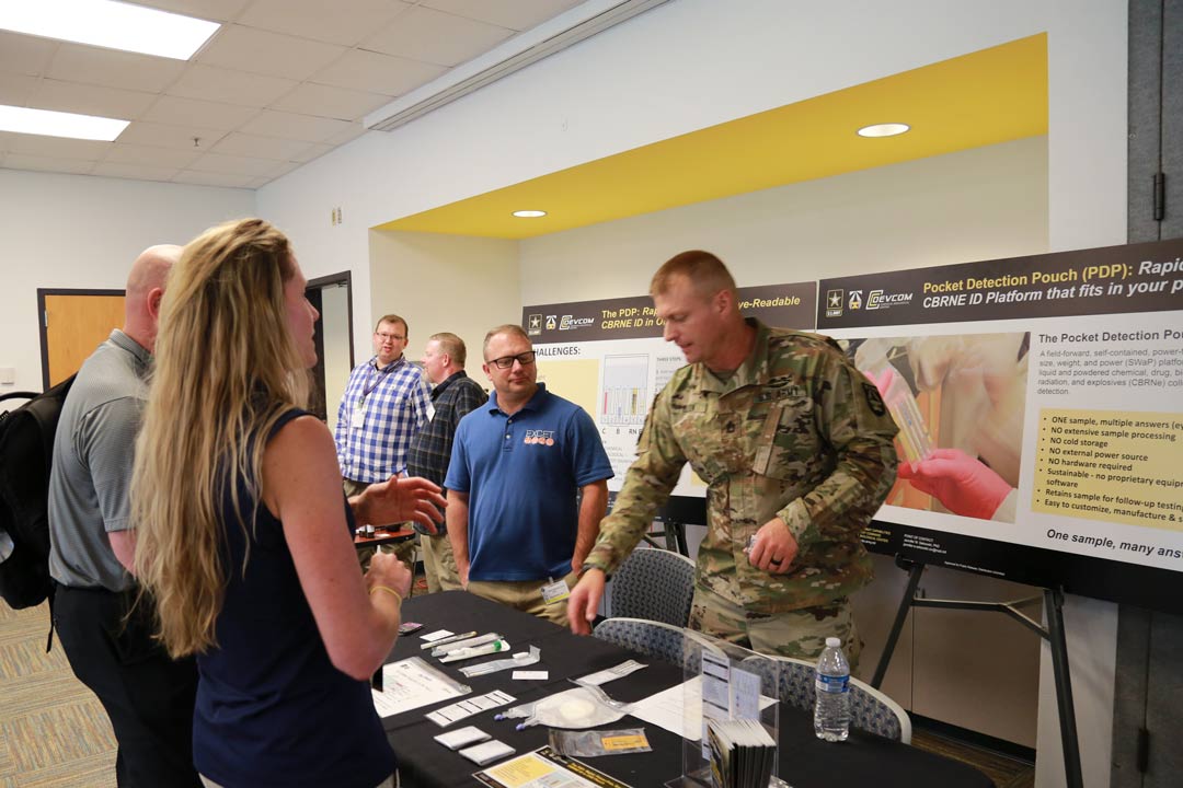 Sgt. 1st Class Robert Olson speaks with stakeholders about a new sample collection pouch developed at the Center. (Photo by Shawn Nesaw, CCDC Chemical Biological Center)
