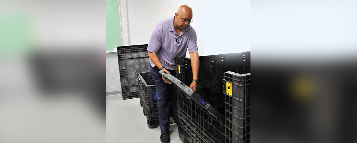 Dexter Jennings demonstrates how the larger crates open, allowing Soldiers easier access to the contents.