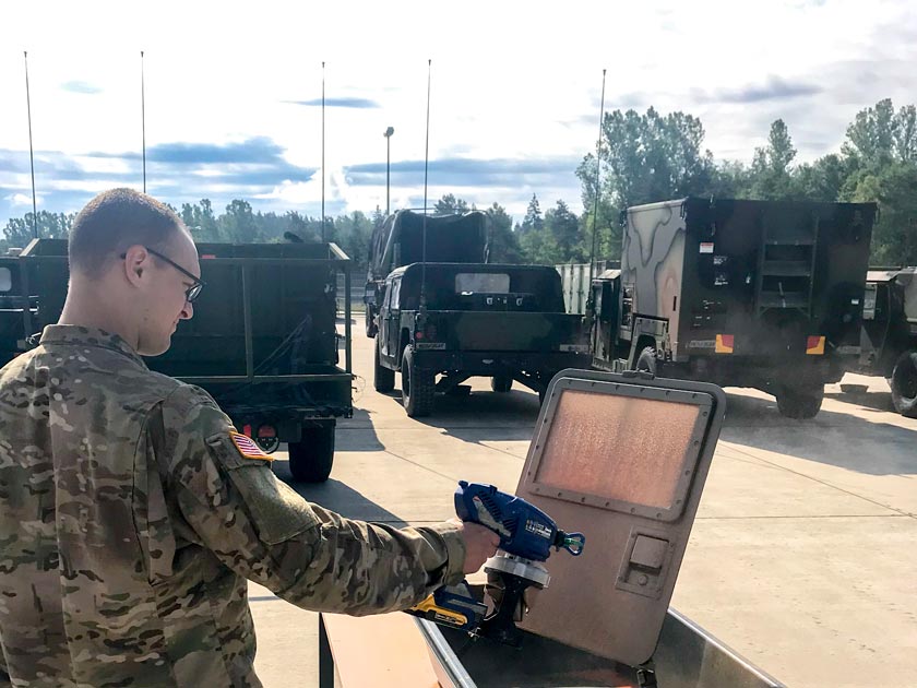 Sgt. Richard Dial of the U.S. Army European Command Chemical Biological Radiological Nuclear Explosive Detachment in Grafenwoehr, Germany applies sprayable decontaminant slurry to a scaled-down Humvee door.