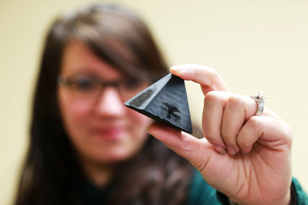 Angela Zeigler, Ph.D., holds one of the 3D printed objects being tested. Photo by Shawn Nesaw.