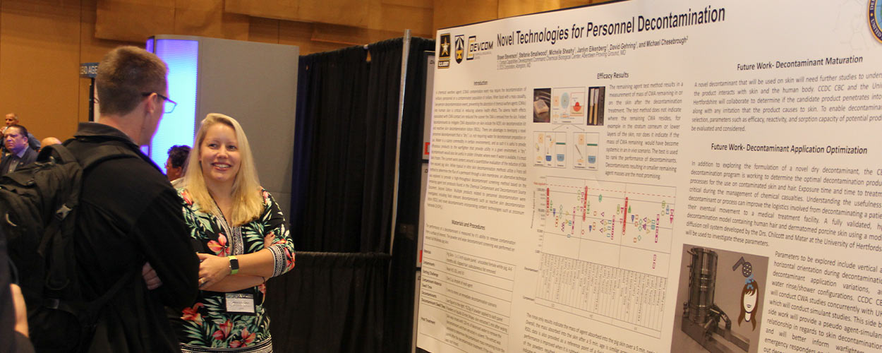CCDC Chemical Biological Center chemist Shawn Stevenson discusses her poster with an attendee during the 2019 CBD S&T Conference.
