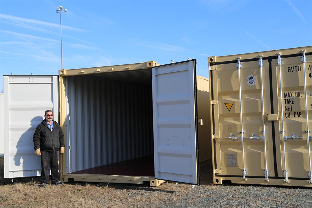 Engineering Technician Alfred Ciolfi of the Advanced CBRNE Training Branch stands with new containers that will simulate home environments for Soldier and first responder urban training.
