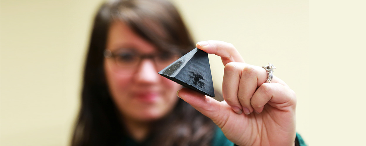 Angela Zeigler, Ph.D., holds one of the 3D printed objects being tested.