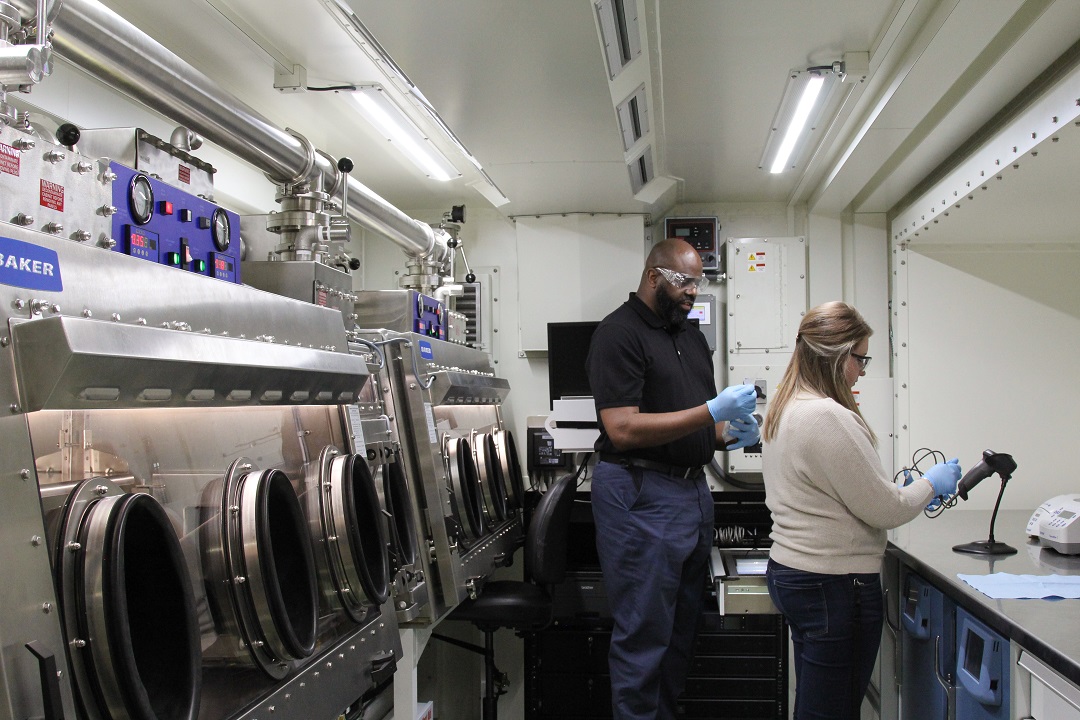 Lennox Brown and Shelby Bartram test the functionality of the equipment inside an Analytical Laboratory Systems Modified Work Order mobile laboratory at a DEVCOM CBC facility at Aberdeen Proving Ground before clearing the system for deployment. (U.S. Army Photo by Ellie White)