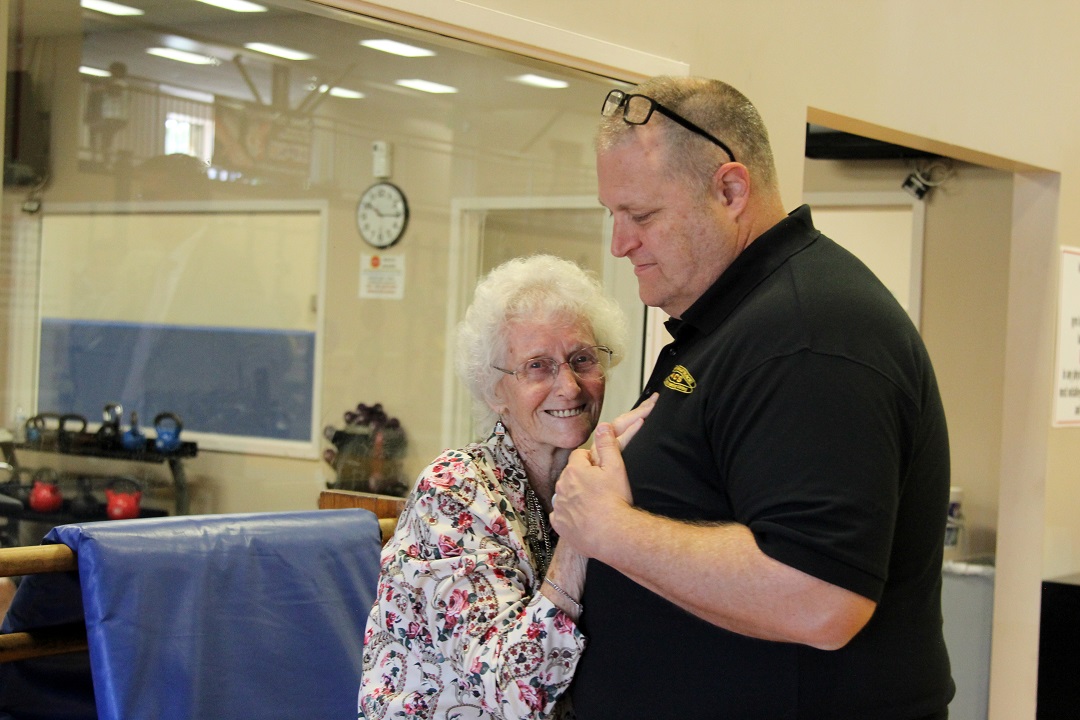 Cecilia Lesser dances with APG Survivor Outreach Services Coordinator Michael Farlow in Hoyle Gymnasium where she once attended NCO club dances with her late husband. (U.S. Army photo by Ellie White)